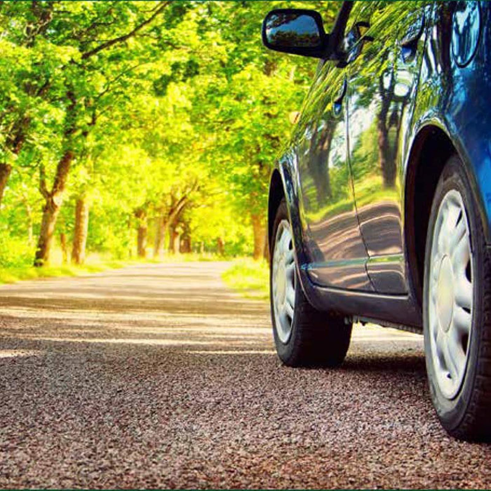 Car driving down a country lane