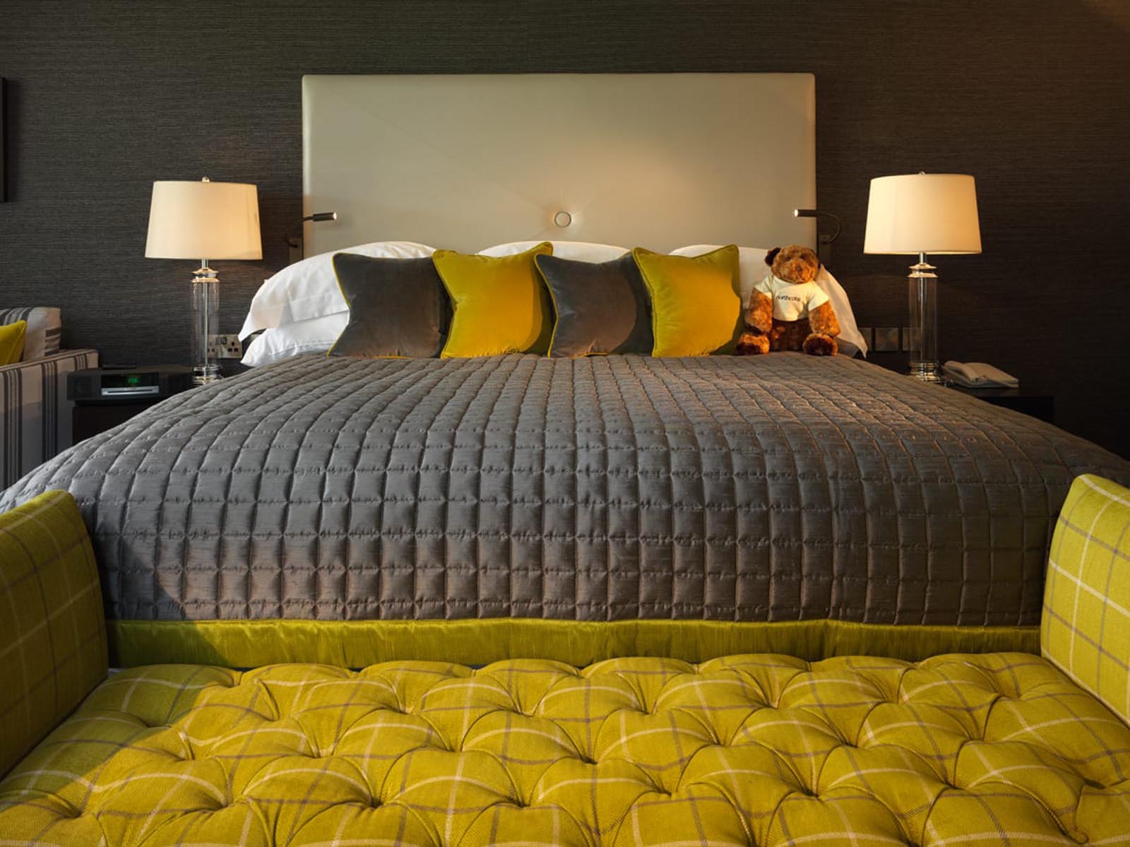 One of our deluxe rooms, a large double bed with seating at the bottom of the bed